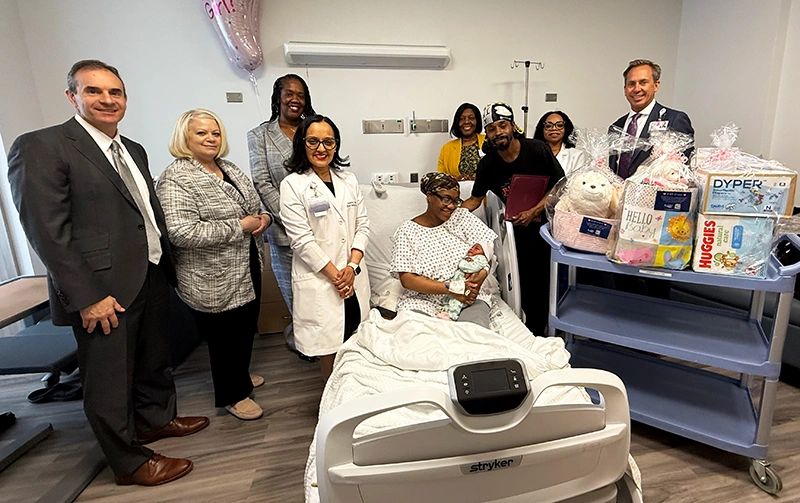 Brandi Rice and Tyrell Green welcomed their daughter Tylinn, into the world on Mother’s Day. They are pictured with Donald T. Morrish, MD, MMM (right), Chief Executive Officer of EHS, and (from left): Steven Guido, Executive Vice President & Chief Financial Officer, Marissa DeLaCruz, MSN, RN, RNC-OB, Director of Nursing, Maternal Child Health, Jameela Yusuff, MD, MPH, Senior Vice President & Chief Medical Officer, Jacqueline Marecheau, MD, FACOG, Chairperson, Department of Obstetrics & Gynecology, Sharika Gordon, Senior Vice President & Chief People Officer, and Roseline Utti, DNP, RN, RNC-OB, C-EFM, Nurse Manager, Maternal Child Health.