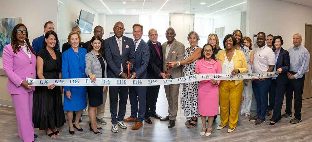 Donald T. Morrish, MD, MMM, Chief Executive Officer at EHS (ninth from left); the Right Rev. Lawrence C. Provenzano, President and Chairman of the EHS Board of Trustees (10th from left); and Jacqueline Marecheau, MD, FACOG, Chair of Obstetrics and Gynecology at EHS (sixth from right), cut the ribbon alongside members of the EHS Board of Trustees, executive leadership, and elected officials, including Queens Borough President Donovan Richards (eighth from left), U.S. Rep. Gregory Meeks (center), NYS Assembly Member Stacey Pheffer Amato (10th from right), Queens District Attorney Melinda Katz (eighth from right), and NYS Assembly Member Khaleel Anderson (fourth from right).
