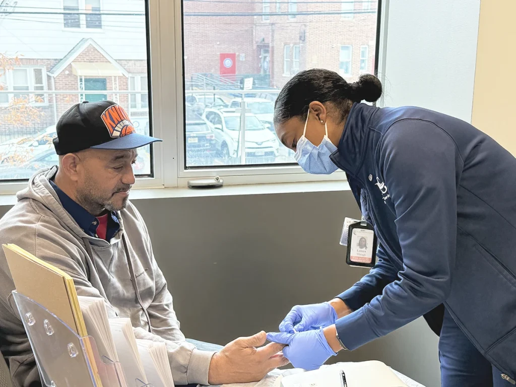 Latoya Maragh, MS, MPH, RN, Public Health Nurse at EHS checked Arverne resident Nicholas Rodriguez’s A1C.
