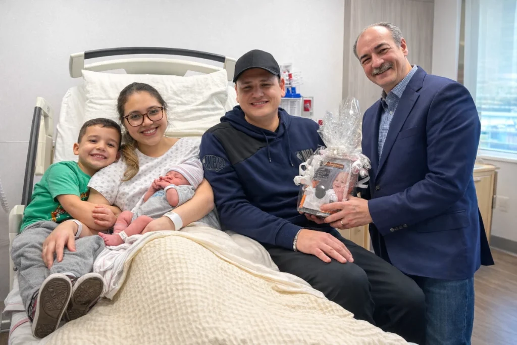 The family is pictured with Joe Caraccia, Senior Executive Vice President of Jzanus, which donated a baby monitor to mark the occasion.