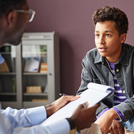 Young Man speaks with a doctor.