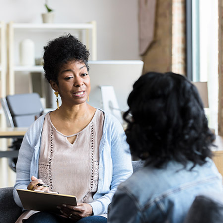 Woman speaks with a psychiatrist.